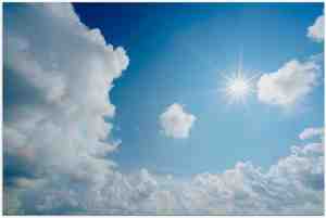 Foto: Poster blauwe lucht met wolken en zon   120x80cm foto op posterpapier